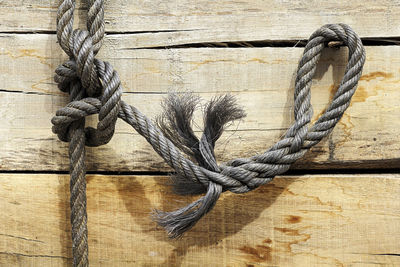 Close-up of sailor knot on wooden plank