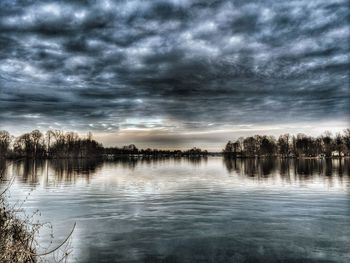 Scenic view of lake against sky at sunset