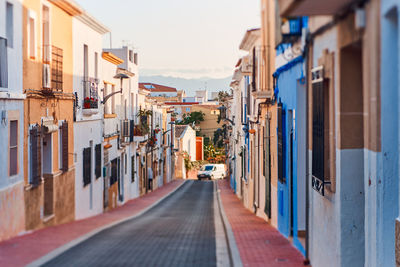 Street amidst buildings against sky