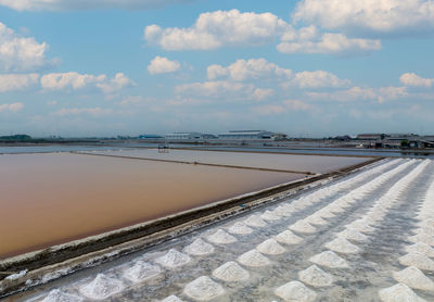 Aerial view of sea salt farm. pile of brine salt. raw material of salt industrial. sodium chloride