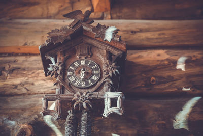 Low angle view of old-fashioned clock on wall