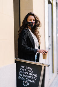 Portrait of woman standing on smart phone