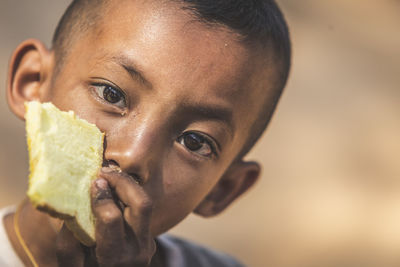 Close-up portrait of boy eating ice cream