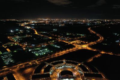 High angle view of illuminated buildings in city at night