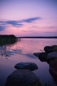 Scenic view of sea against romantic sky at sunset