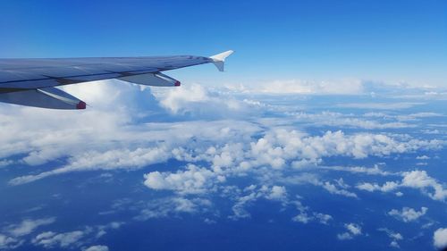 Cropped image of airplane flying against sky