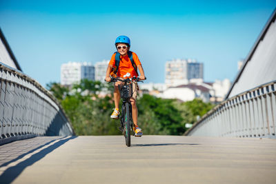 Portrait of boy standing by railing