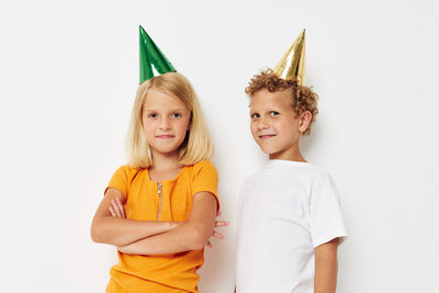 Portrait of smiling sibling wearing party hat