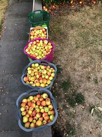 High angle view of apples in baskets outdoors