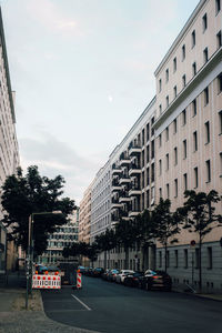 City street and buildings against sky