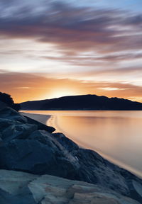 Scenic view of lake against sky during sunset