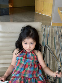 Portrait of girl sitting on floor