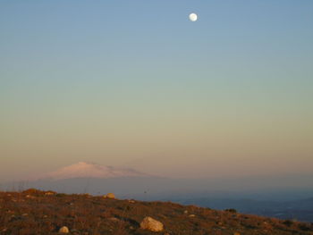 Scenic view of landscape against clear sky at night