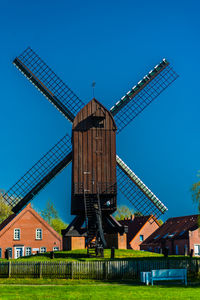 Traditional windmill against clear blue sky