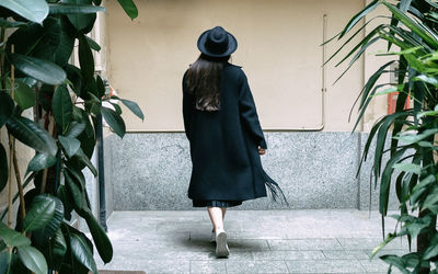 Rear view of woman walking in corridor