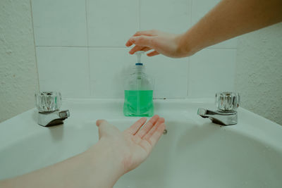 Cropped image of hand holding glass of water