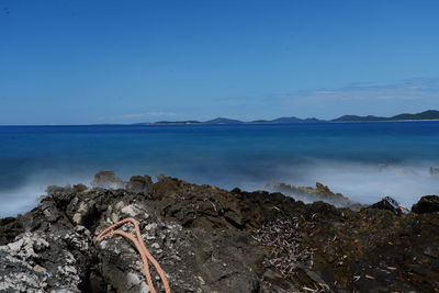 Scenic view of sea against clear blue sky