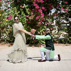 Full length of mother and daughter against white wall