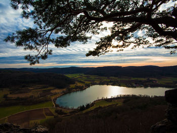 Scenic view of lake against sky at sunset