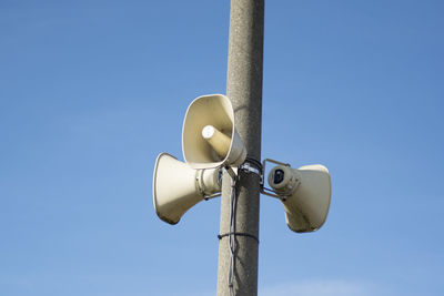 Low angle view of street light against clear blue sky