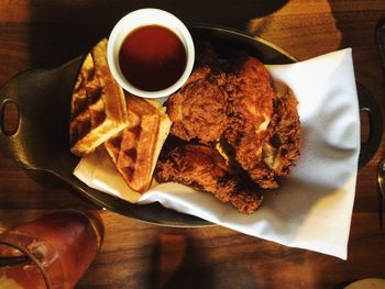 Directly above shot of waffles with fried chicken and coffee in plate