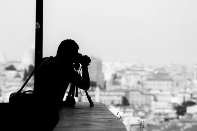 Woman photographing in city