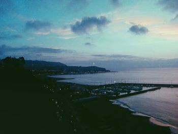 Scenic view of sea by city against sky