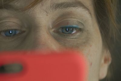 Close-up of woman looking at mobile phone