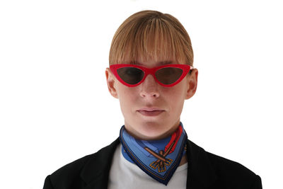 Portrait of boy wearing sunglasses against white background