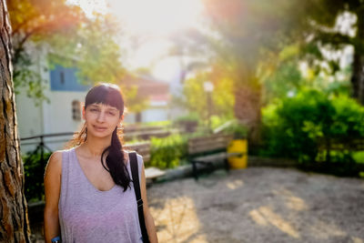 Portrait of young woman standing outdoors