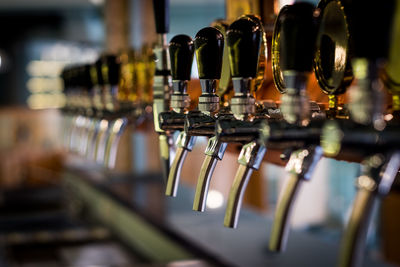 Row of draft beer tab on the top of counter bar in closeup view, time of celebration.