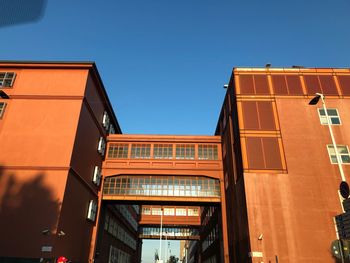 Low angle view of buildings against clear blue sky