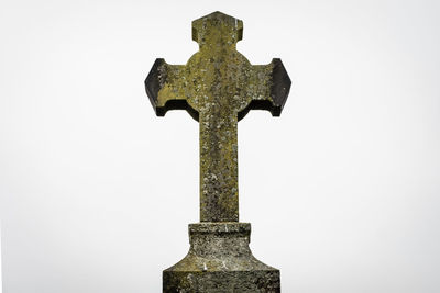 Close-up of cross against clear sky