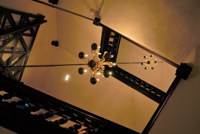 Low angle view of illuminated chandelier against sky