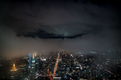 Aerial view of city lit up at night