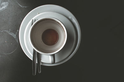 Directly above shot of coffee cup over black background