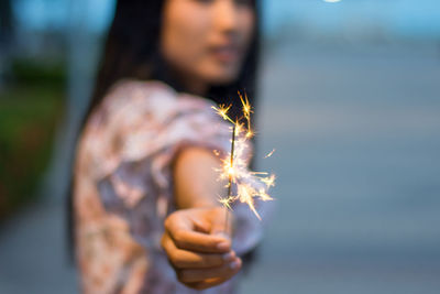Midsection of woman holding plant