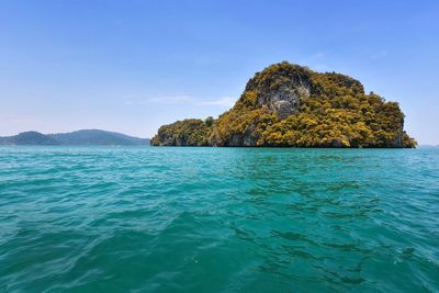 Rock formation in sea against sky