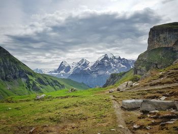 Scenic view of rocky mountains against cloudy sky