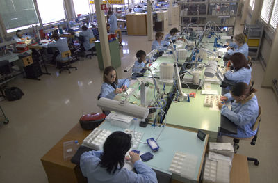 High angle view of watch makers working in industry