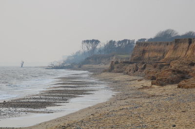 Scenic view of beach against clear sky