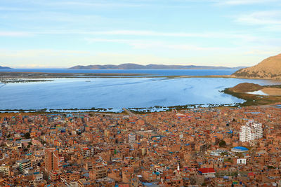 Aerial view of lake titicaca and the city of puno view from the condor hill view point in puno, peru