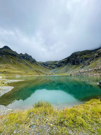 Scenic view of lake and mountains against sky