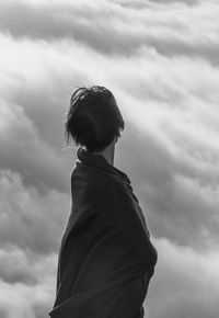 Rear view of woman standing against sky