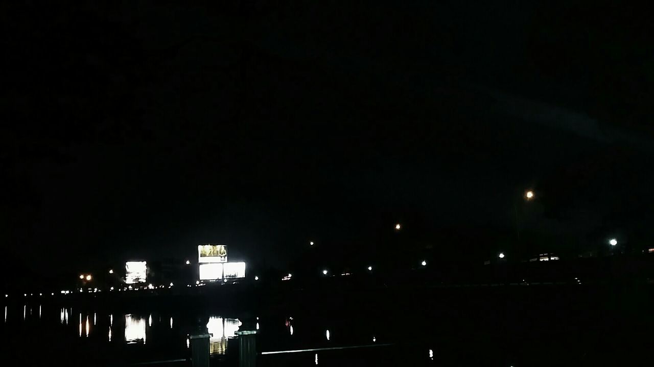 ILLUMINATED BUILDINGS IN CITY AT NIGHT