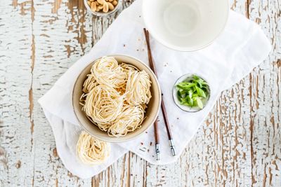 High angle view of noodles and ingredients on table