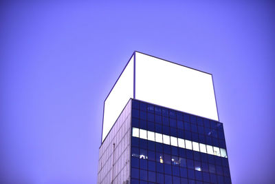 Low angle view of modern building against blue sky