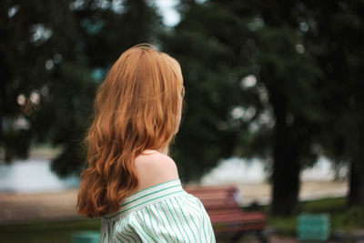 Side view of woman standing at park