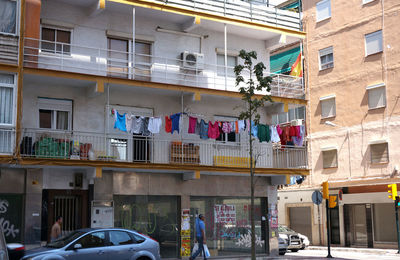 Cars on street by buildings in city