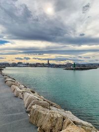 Scenic view of sea by city against sky